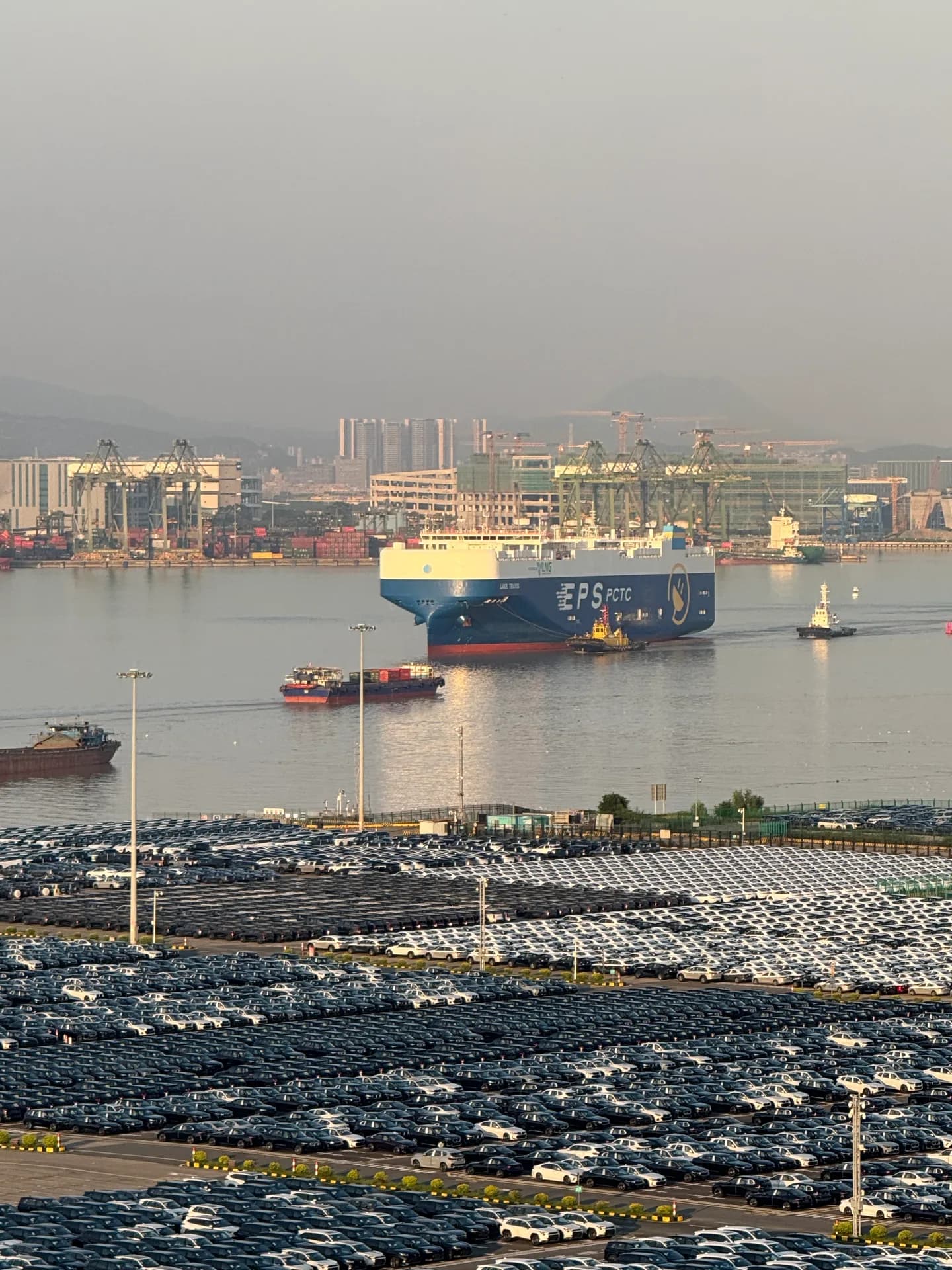 A vehicle carrier and port-side vehicle storage